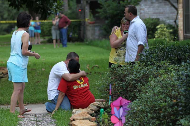 Neighbors embrace each other following a shooting Wednesday, July 9th, 2014, in Spring. Seven people were shot, with six confirmed dead. — Photo: Brett Coomer/Houston Chronicle.