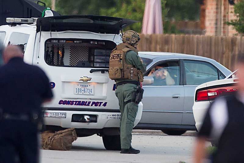 Law enforcement officers surround a shooting suspect in his car Wednesday, July 9th, 2014, in Spring. Seven people were shot, with six confirmed dead. — Photo: Brett Coomer/Houston Chronicle.