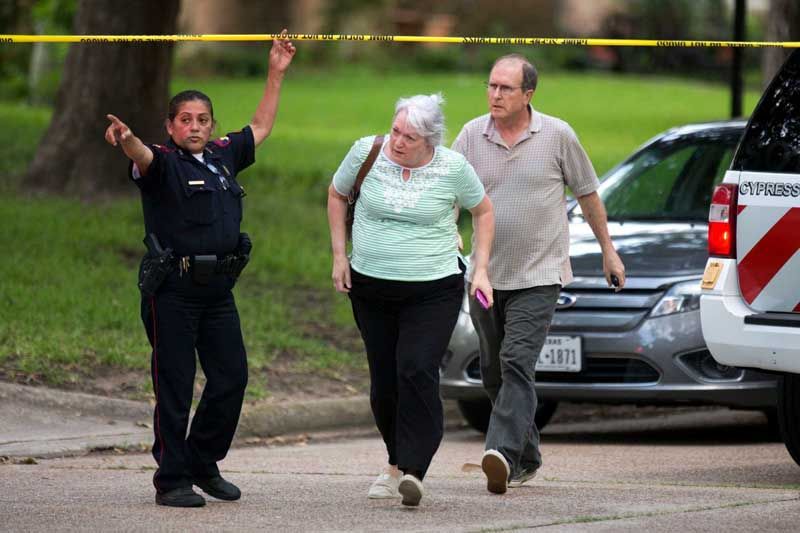 A man and woman are let through the police line to speak with officers following a shooting Wednesday, July 9th, 2014, in Spring. Seven people were shot, with six confirmed dead. — Photo: Brett Coomer/Houston Chronicle.