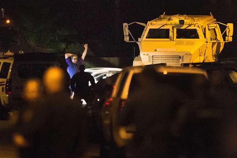 A shooting suspect surrenders to law enforcement officers after 4-hour standoff on Wednesday, July 9th, 2014, in Spring. The suspect is believed to have shot seven people, with a number of fatalities reported. — Photo: Brett Coomer/Houston Chronicle.