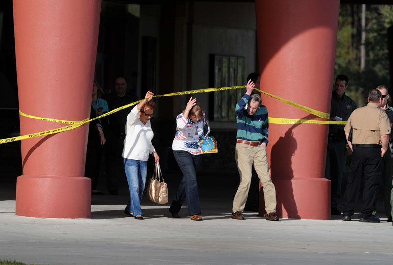 Patrons leave the Grove 16 theater after the shooting Monday afternoon.  Photo: Cliff McBride/The Tampa Herald.