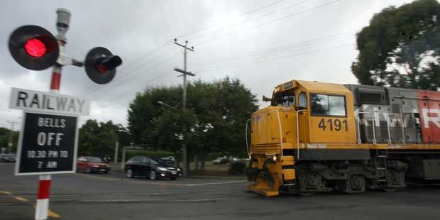 TOO CLOSE: A car dodging past stopped cars in front of a train at the Renall Street crossing in Masterton is one of nearly 20 near misses so far this year in New Zealand.  LYNDA FERINGA/Wairarapa Times-Age.