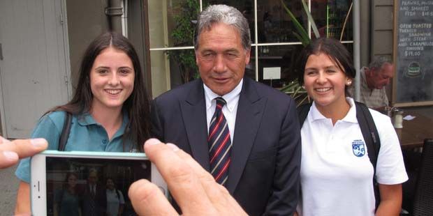 Kerikeri 14-year-olds Hannah Bindon, left, and Issy Joe get a photo with NZ First leader Winston Peters.  Photo: Peter de Graaf.