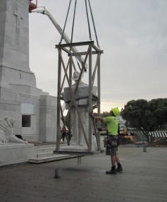 Gisborne's soldier is loaded into a cage before being lifted onto the cenotaph.