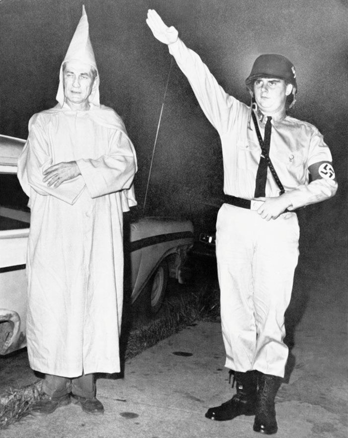 Clarence Brandenburg, 48, who says hes an officer in the Ku Klux Klan, left, and Richard Hanna, 21, admitted member of the American Nazi Party, pose for picture following their arrests, August 8th, 1964, Cincinnati, Ohio. — Photo: Associated Press.