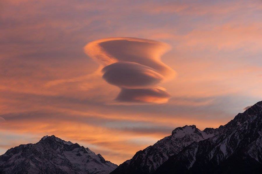 The smooth surface of a lenticular cloud at sunrise.