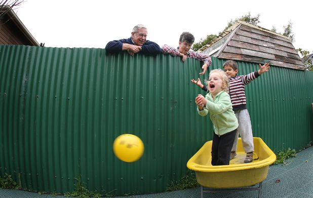 More good neighbours: Ossie and Jenny Fountain look over their back fence at Arabella Waugh and Seth Butler  both four years of age  of Tui Park Kindergarten.  Photo: Diego Opatowski/Fairfax NZ.