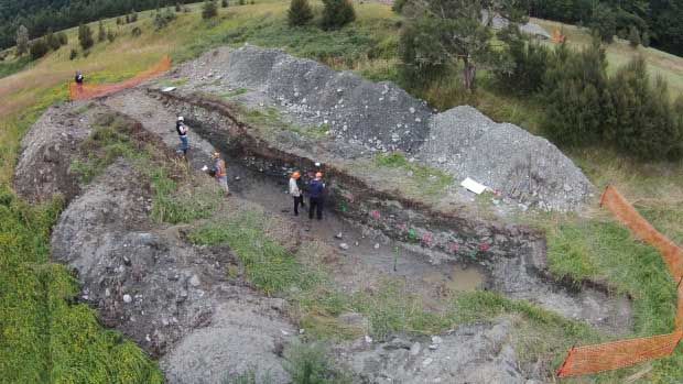 GNS Science earthquake geologists studying layers in the trench across the Alpine Fault at Springs Junction.  Photo: GNS Science.