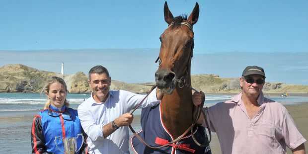 Minister of Racing Nathan Guy, centre, with 2016 Castlepoint Cup winner Sea King, jockey Kayla Veenendaal and seven-time trainer of cup winners, Kevin Myers. — Photograph: Chris Kilford.