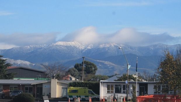The first real snowfall of 2016 blankets the Tararua Range behind Masterton's Wellington Free Ambulance station, at the northern end of Chapel Street. — Photograph: Caleb Harris/Fairfax NZ.