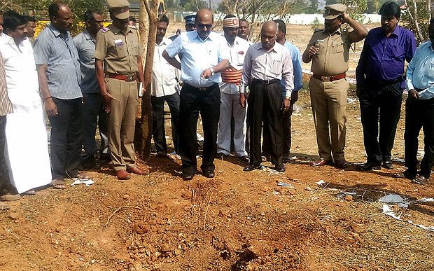 Indian authorities inspect the site of the suspected meteorite impact.  Photograph: AFP/Getty Images.