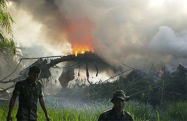 HORROR CRASH: Fire razes through an Indonesian Air Force C-130 cargo plane after it crashed in Magetan, East Java, Indonesia.  Associated Press.