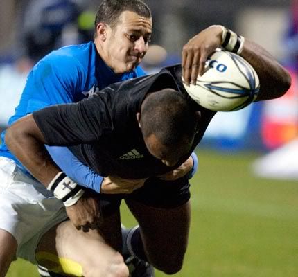 New Zealand's Josevata Rokocoko dives over to score a try in the tackle of Italy's Kaine Robertson.