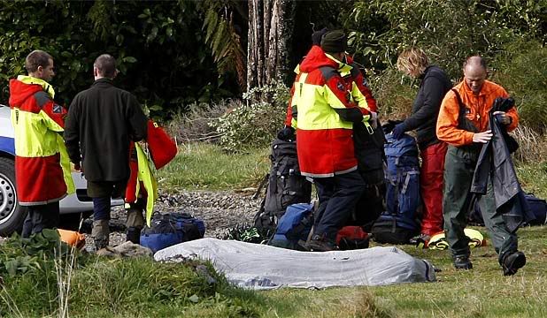 FOUND: Searchers with the bodies of Dr Seddon Bennington and Marcella Jackson at the foothills of the Tararua Ranges.