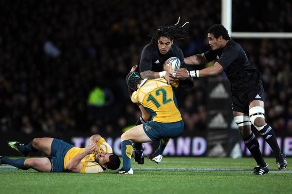 Second five Ma'a Nonu is tackled by Berrick Barnes with lock Jerome Kaino in support.  Photosport.