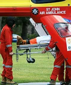 UNLUCKY: Westpac Rescue Helicopter personnel arrive in Timaru with the body of an Australian tourist who died in an avalanche while heliskiing yesterday. — JEFF TOLLAN/ The Timaru Herald.