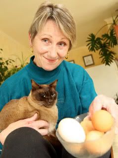 TRICKY TOM: Charlie the egg stealer with owner Cheryl Amor, who says: “The neighbour's got about five cats of his own so I'm sure he wouldn't hurt Charlie but I'm taking the eggs back.” — BRETT MEAD/Brett Mead Photography.