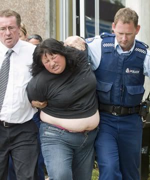 DISGRACEFUL EXHIBITION: Victoria Stevens, mother of murder accused Hulio Ataria, is taken from Hastings District Court yesterday after her arrest for contempt of court.