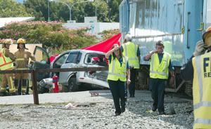 SHOCK: Distressed KiwiRail staff walk away from the scene of a fatal accident on Kinross Street yesterday. A 78-year-old Blenheim man was killed after the TranzCoastal train with 163 passengers on board and his car collided on the crossing. SCOTT HAMMOND/The Marlborough Express.