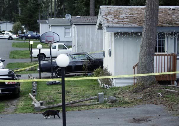 A home is ringed with police tape Saturday at trailer park near Graham, Wash., where the bodies of five children were discovered dead in their home Saturday afternoon. TED S WARREN/Associated Press.