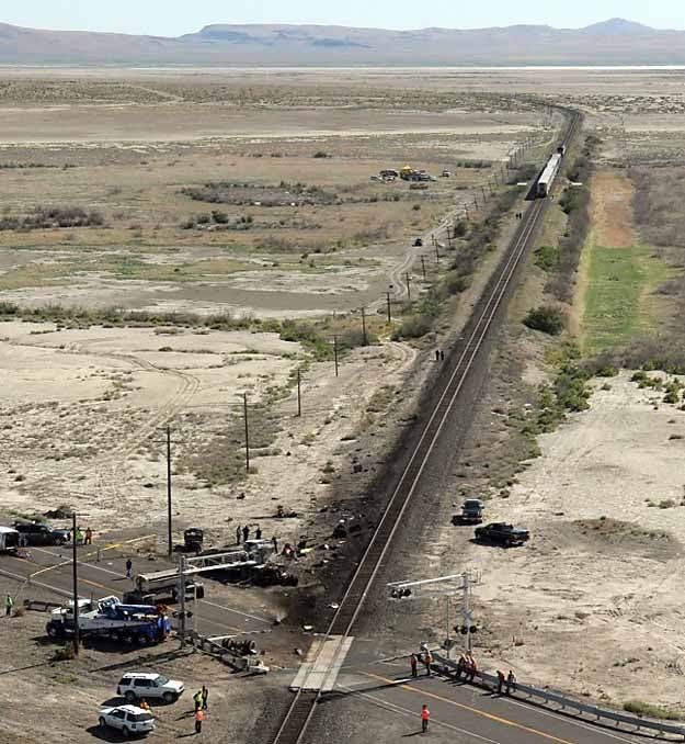The wreckage of a truck is seen at right at the site of a collision between an Amtrak westbound train and a truck on U.S. 95 about 4 miles south of Interstate 80 on Friday, 70 miles east of Reno, Nevada. — Photo: Marilyn Newton/Associated Press.