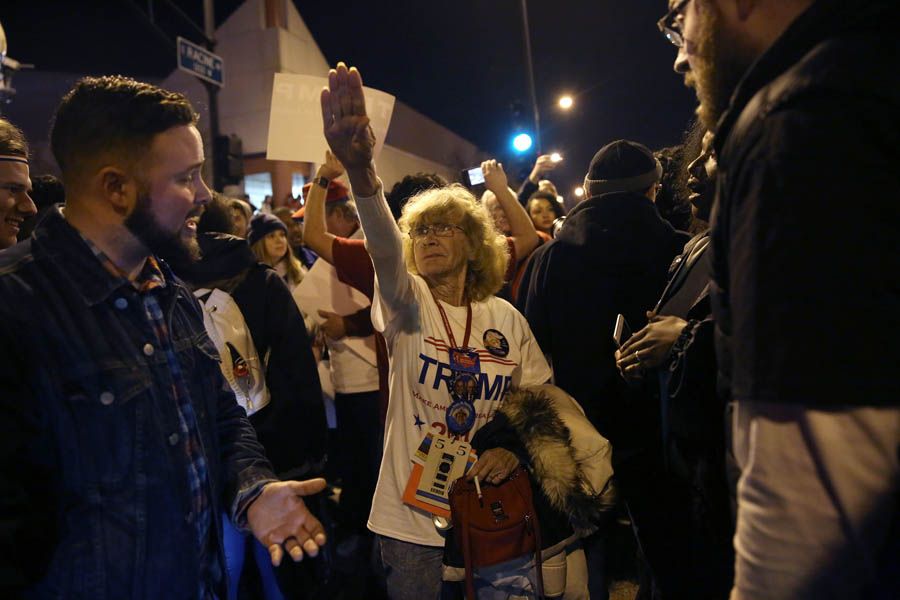 Donald Trump supporter Birgitt Peterson, centre, of Yorkville, argues with protesters outside the UIC Pavilion after the canceled rally for the Republican presidential candidate. — Photograph: E. Jason Wambsgans/Chicago Tribune.