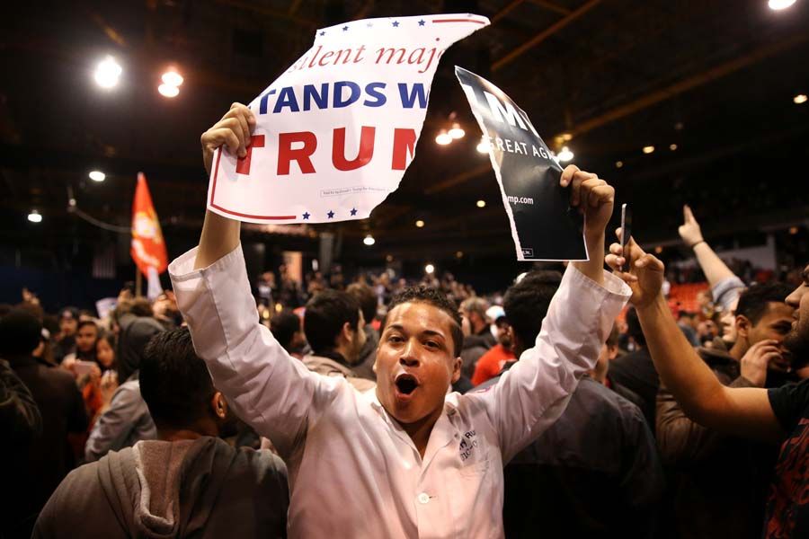 A protester shows off ripped Donald Trump campaign signs after it was announced the rally for the Republican presidential candidate was cancelled at the UIC Pavilion in Chicago. — Photograph: Chris Sweda/Chicago Tribune.