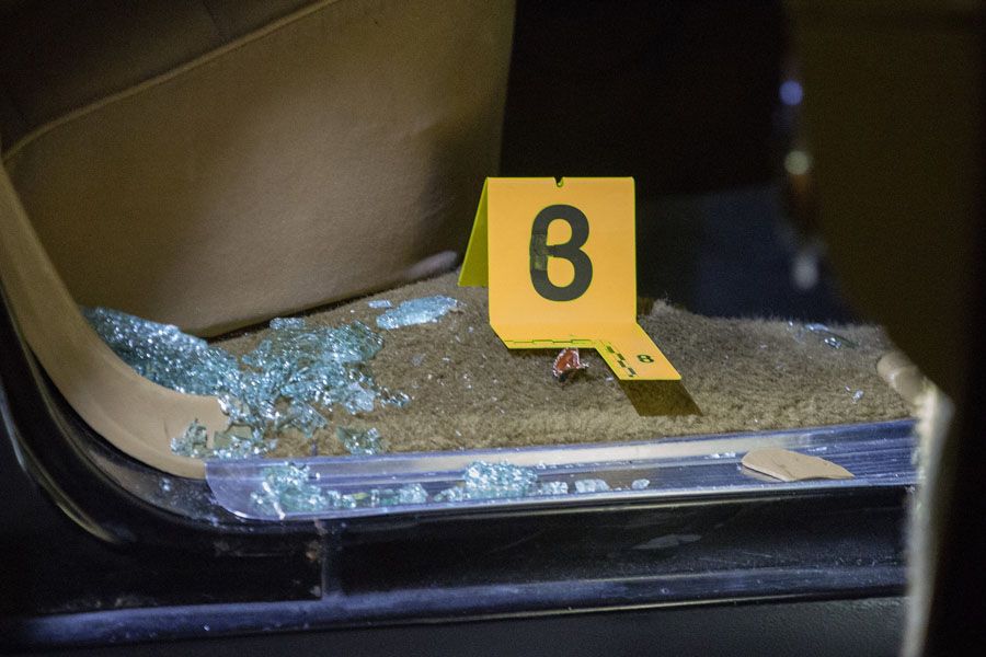 An evidence marker is placed inside vehicle involved in a shooting in the 3300 block of West Douglas Boulevard while it is parked outside Mount Sinai Hospital on September 6th, 2016. Two men were shot and drove themselves to the hospital. — Photograph: Erin Hooley/Chicago Tribune.