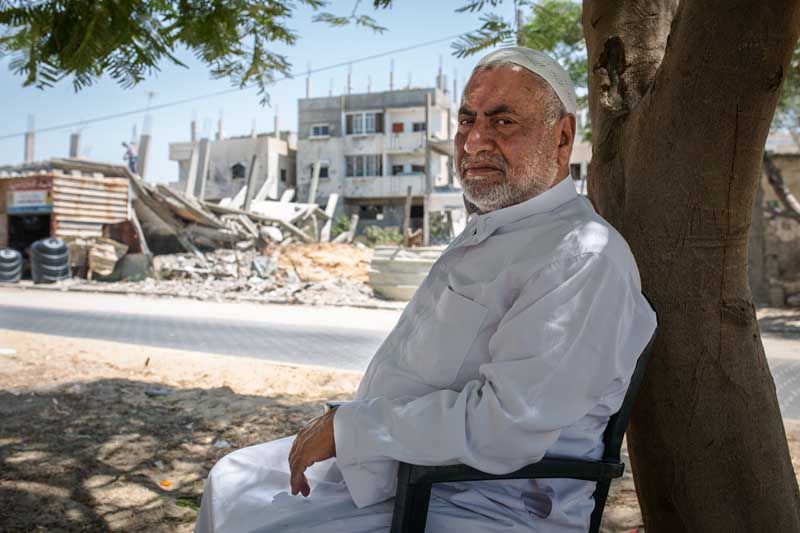 Rateb Bilbisi, of the al-Tannur neighborhood, said Palestinians from east Rafah were seeking shelter from the sun under the trees and awnings when huge explosions toppled the building across the street, leaving more than 16 dead, all of them civilians.