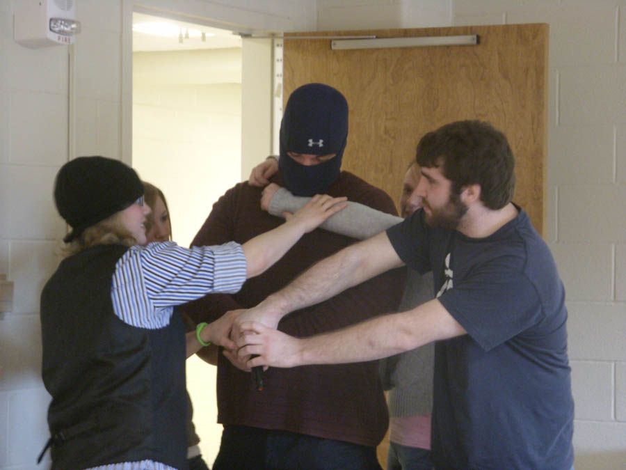 Students at the University of Toledo are taught how to swarm and disrupt a gunman during a training session by the ALICE Institute.  Photograph: University of Toledo Police Department.