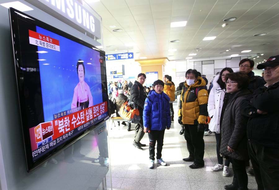 People watch a television news program showing North Korea's announcement, at the Seoul Railway Station in Seoul, South Korea. — Photograph: Ahn Young-Joon/Associated Press.