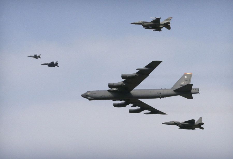 A U.S. Air Force B-52 bomber accompanied by South Korean F-15 and U.S. F-16 fighters flies over Osan Air Base in Pyeongtaek, South Korea on Sunday, January 10th, 2016.  Photograph: Ahn Young-joon/Associated Press.