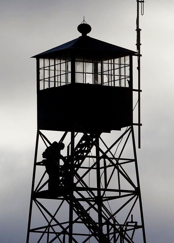 Armed occupiers take lookout duty in this watchtower at the Malheur refuge near Burns, Oregon. — Photograph: Rick Bowmer/Associated Press.
