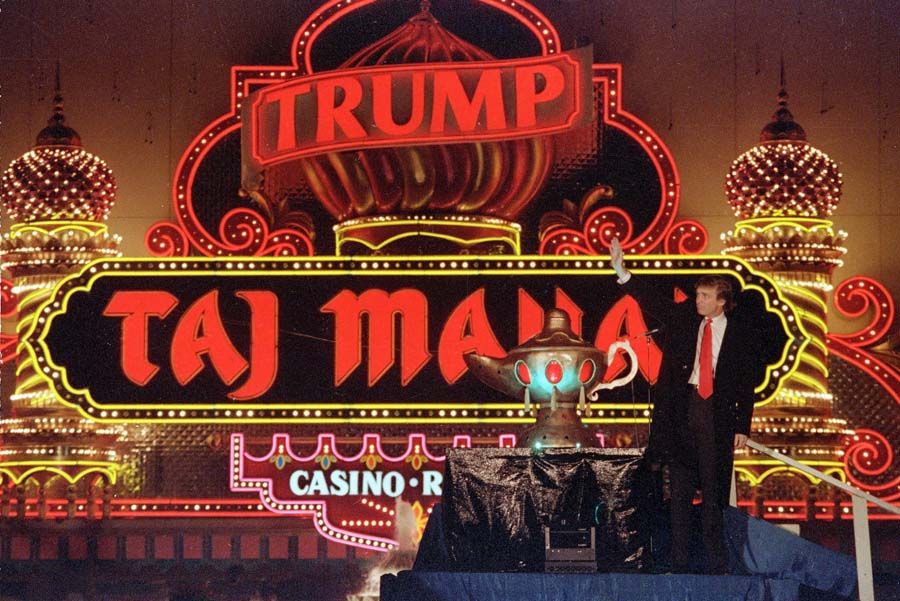 Donald Trump, who currently seeks the Republican nomination in the presidential election, stands next to a genie lamp at the Trump Taj Mahal, marking the grand opening of the venture in Atlantic City, New Jersey on April 5th, 1990. — Photograph: Mike Derer/Associated Press.