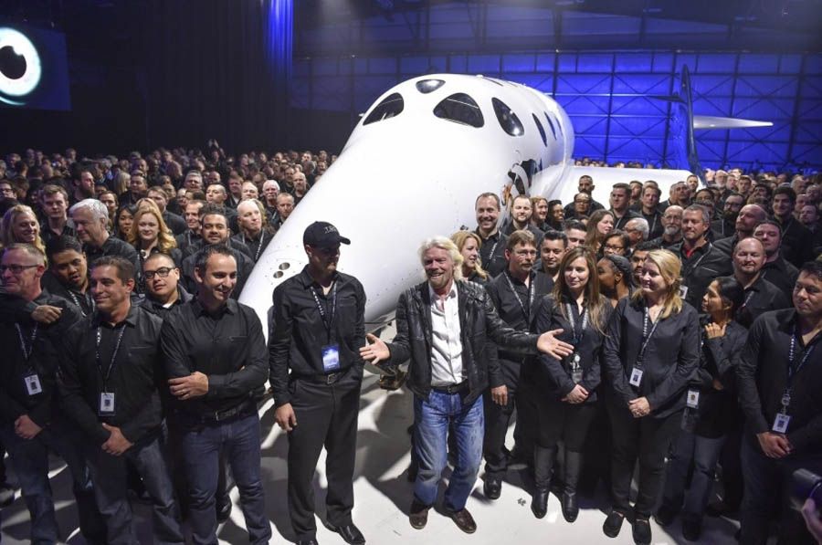 Virgin Galactic's Richard Branson, front center, gathers with Virgin Galactic employees in front of the new SpaceShipTwo. — Photograph: Ricky Carioti/The Washington Post.