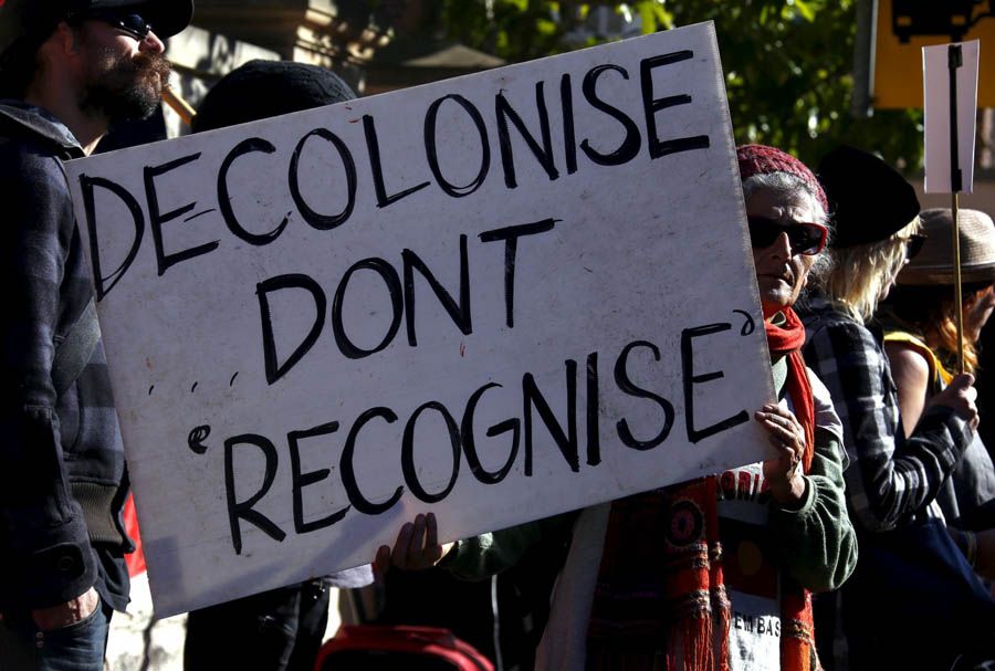 Aboriginal protesters hold banners and chant slogans during a protest outside a government office building in Sydney, Australia, on July 6th, 2015. — Photograph: David Gray/Reuters.