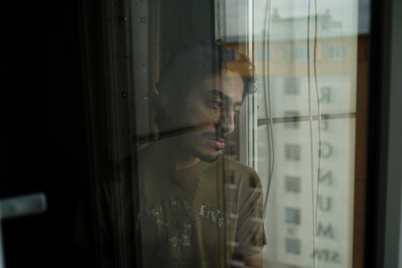 Karam al-Hamad looks out the window of his apartment in Gaziantep, Turkey, in 2014, after his release from prison. — Photograph: Ayman Oghanna/The Washington Post.